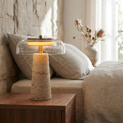 Natural travertine mushroom lamp styled bedside with linen bedding and warm light