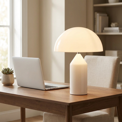 Modern mushroom table lamp on a desk beside a laptop in a home office