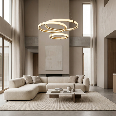 Modern ring LED chandelier in a double-height living room above a sofa