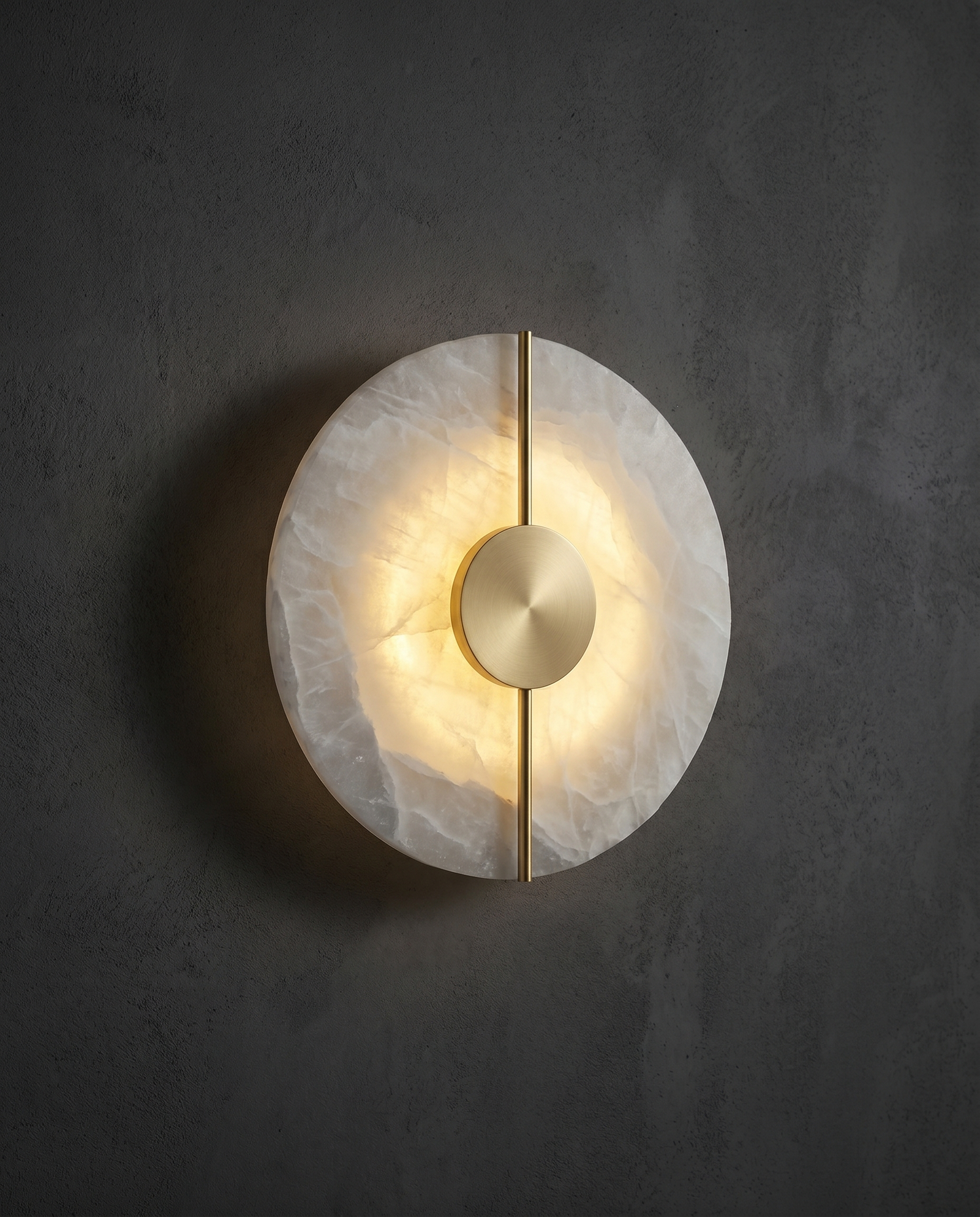 Marble & Copper Moon alabaster wall sconce glowing on a dark charcoal wall