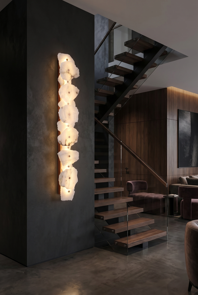 Tall alabaster linear sconce beside a modern staircase