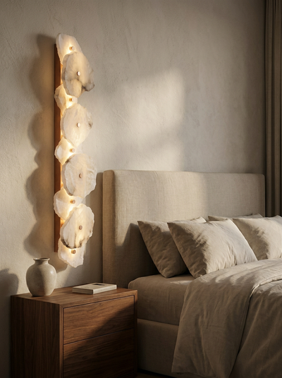 Spanish alabaster linear sconce beside an upholstered headboard